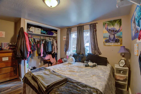 a bed room with a bed and a window