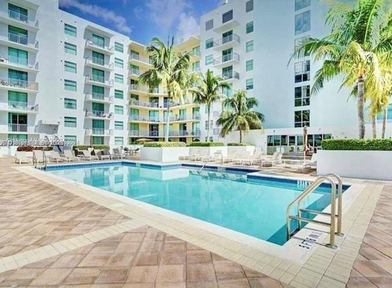 140 South Dixie Highway, Unit 921 Hollywood, FL 33020 - Photo 24 of 30 a view of swimming pool with outdoor seating and plants