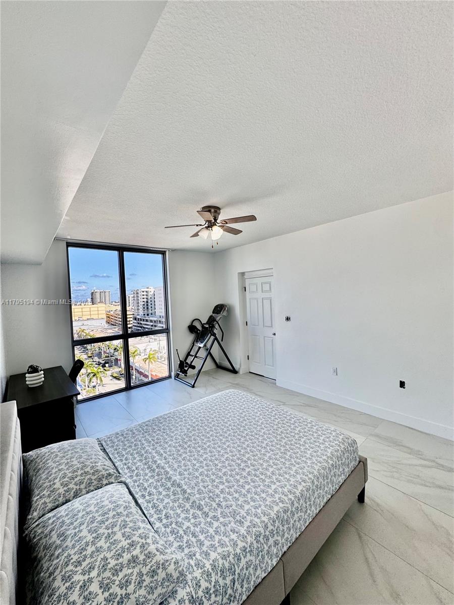 140 South Dixie Highway, Unit 921 Hollywood, FL 33020 - Photo 7 of 30 a bedroom with a bed large window and flat screen tv