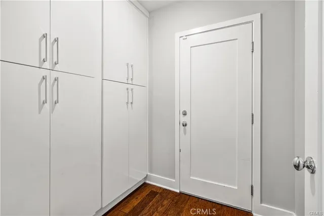 a view of a room with wooden floor