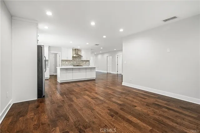 a view of a kitchen with a sink and a refrigerator