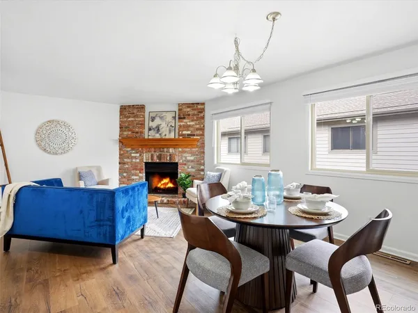 a view of a dining room with furniture a chandelier and wooden floor