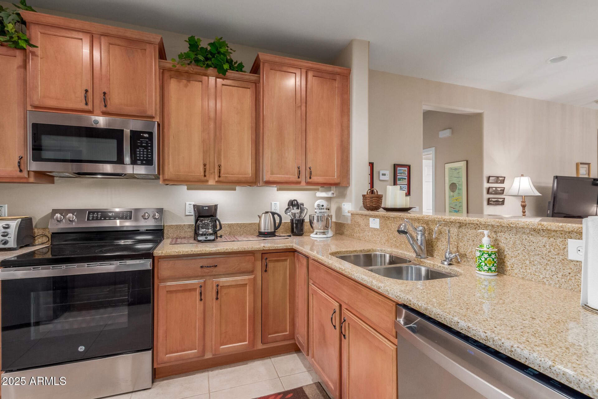 6573 West Mockingbird Way Florence, AZ 85132 - Photo 8 of 36 a kitchen with granite countertop a sink and stainless steel appliances
