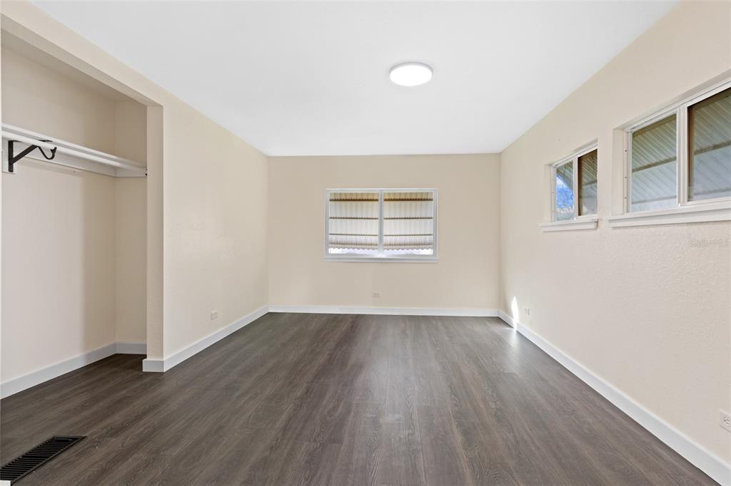 29129 Johnston Road, Unit 2626 Dade City, FL 33523 - Photo 13 of 31 an empty room with wooden floor and windows
