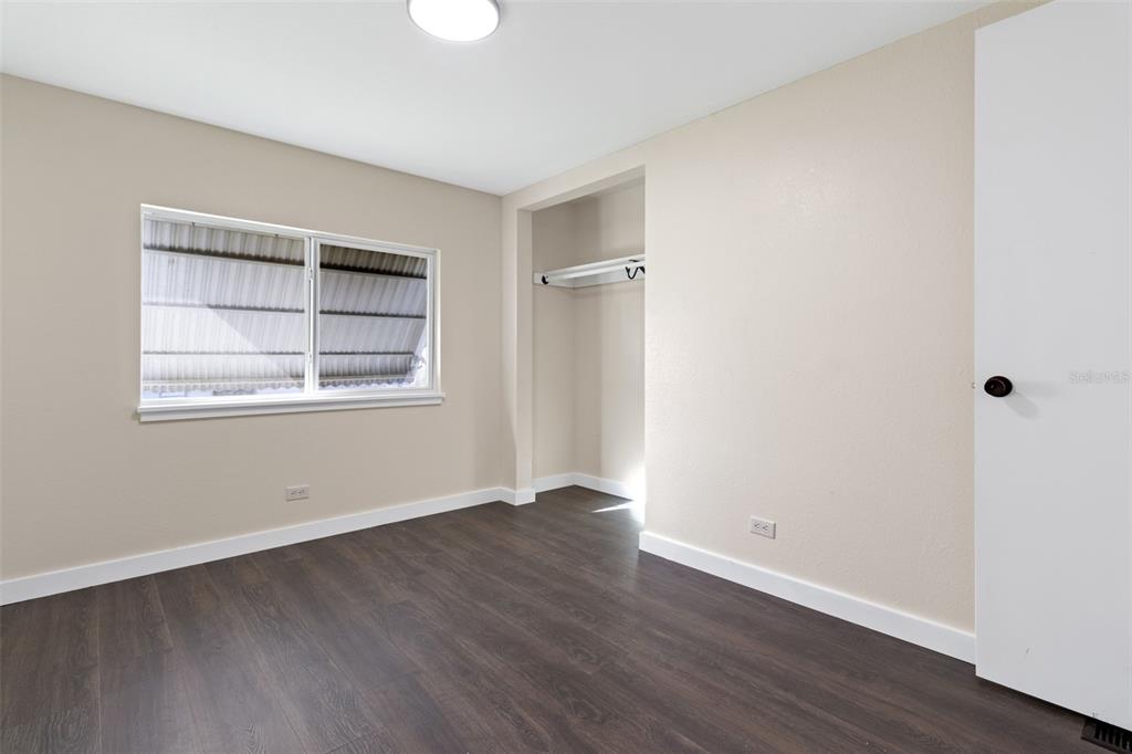 29129 Johnston Road, Unit 2626 Dade City, FL 33523 - Photo 15 of 31 an empty room with wooden floor and windows