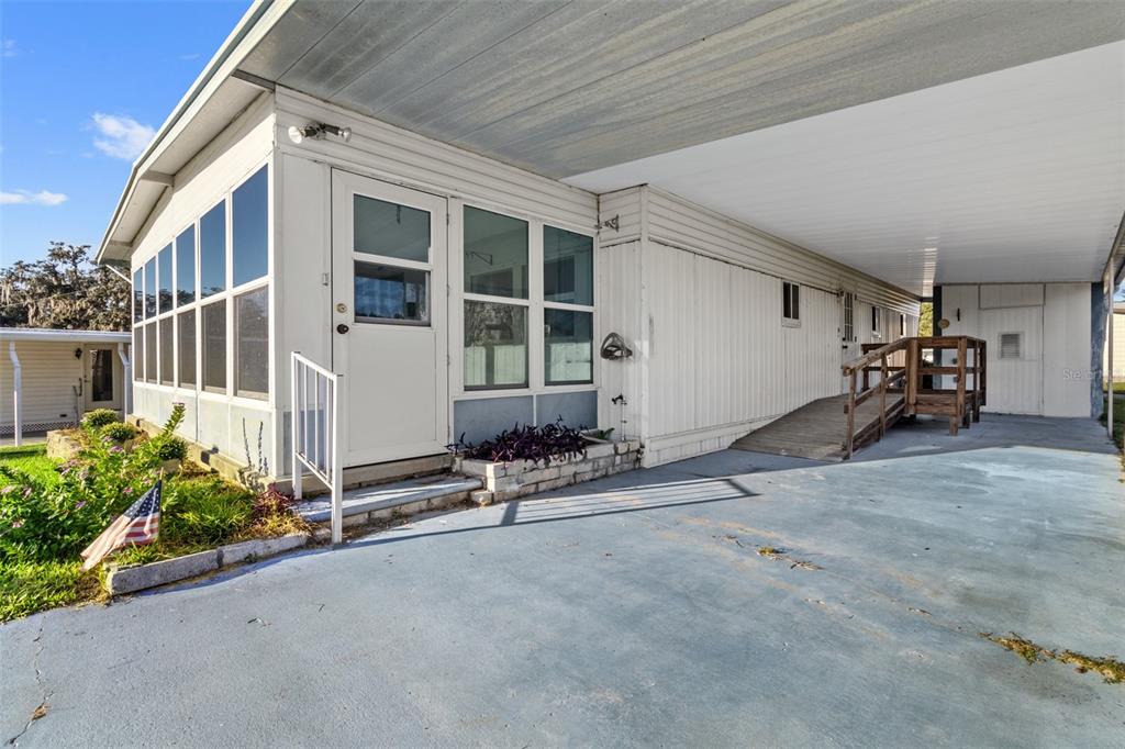 29129 Johnston Road, Unit 2626 Dade City, FL 33523 - Photo 19 of 31 a view of a house with porch and sitting area