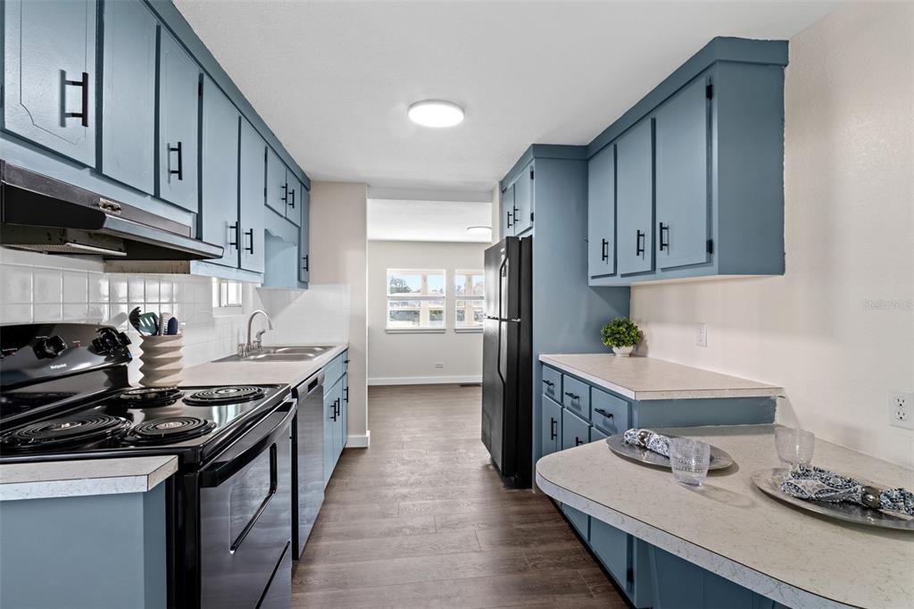 29129 Johnston Road, Unit 2626 Dade City, FL 33523 - Photo 2 of 31 a kitchen with stainless steel appliances a sink stove and cabinets