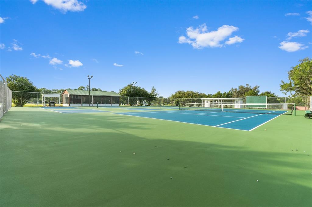 29129 Johnston Road, Unit 2626 Dade City, FL 33523 - Photo 25 of 31 a view of a tennis ground with a big yard