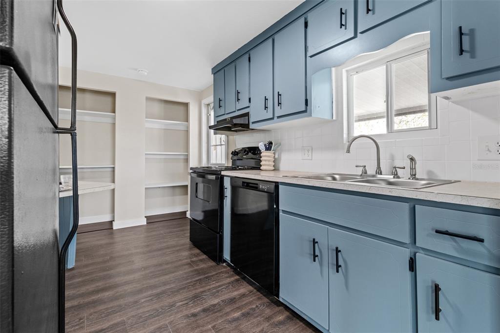 29129 Johnston Road, Unit 2626 Dade City, FL 33523 - Photo 5 of 31 a kitchen with a sink a refrigerator and cabinets