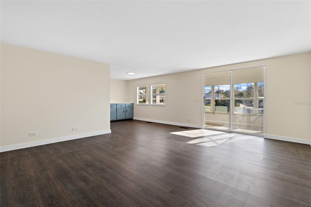 29129 Johnston Road, Unit 2626 Dade City, FL 33523 - Photo 8 of 31 an empty room with wooden floor and windows