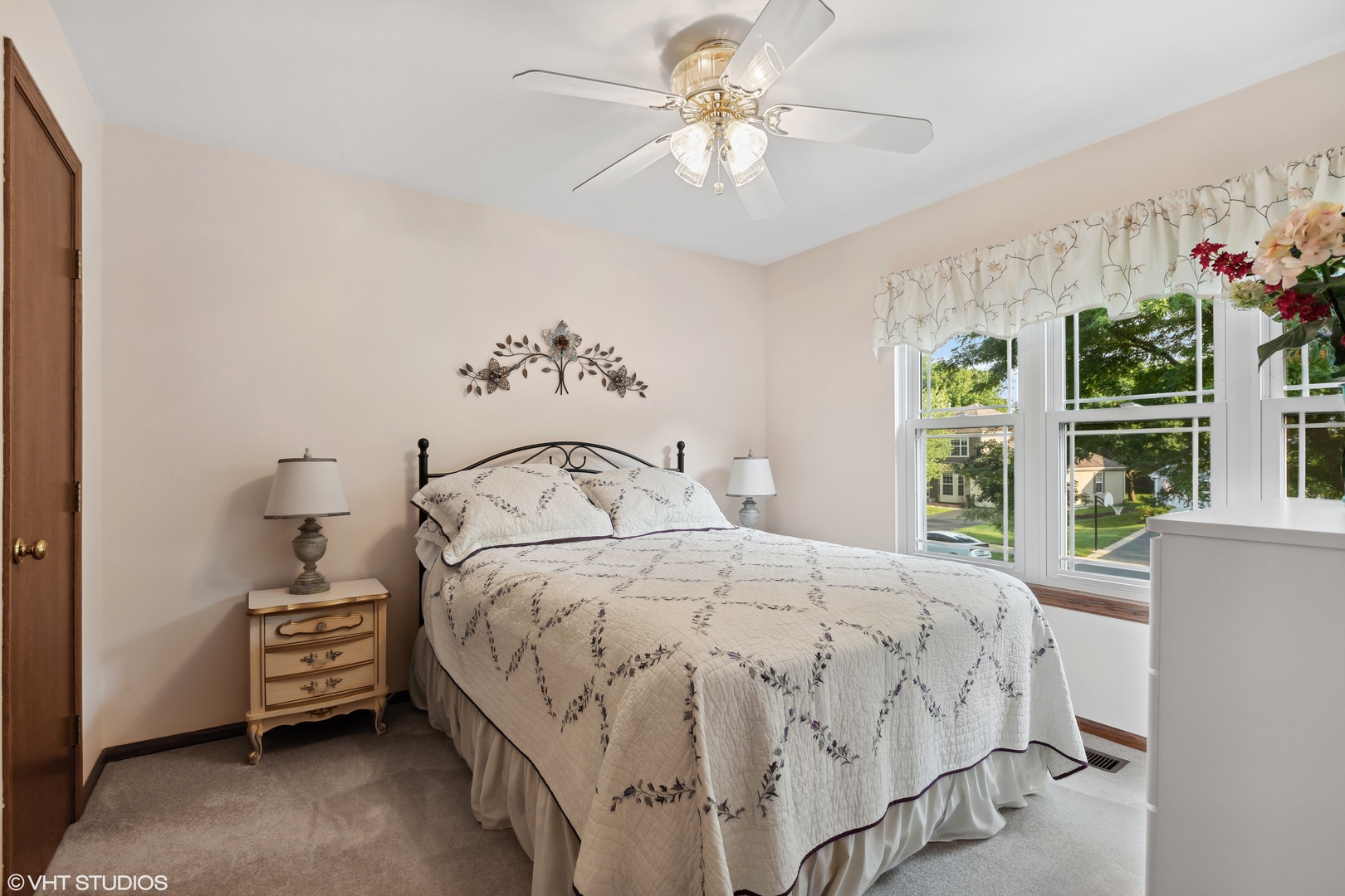 966 Ridgewood Drive Cary, IL 60013 - Photo 18 of 31 a bedroom with a bed a chandelier and a window