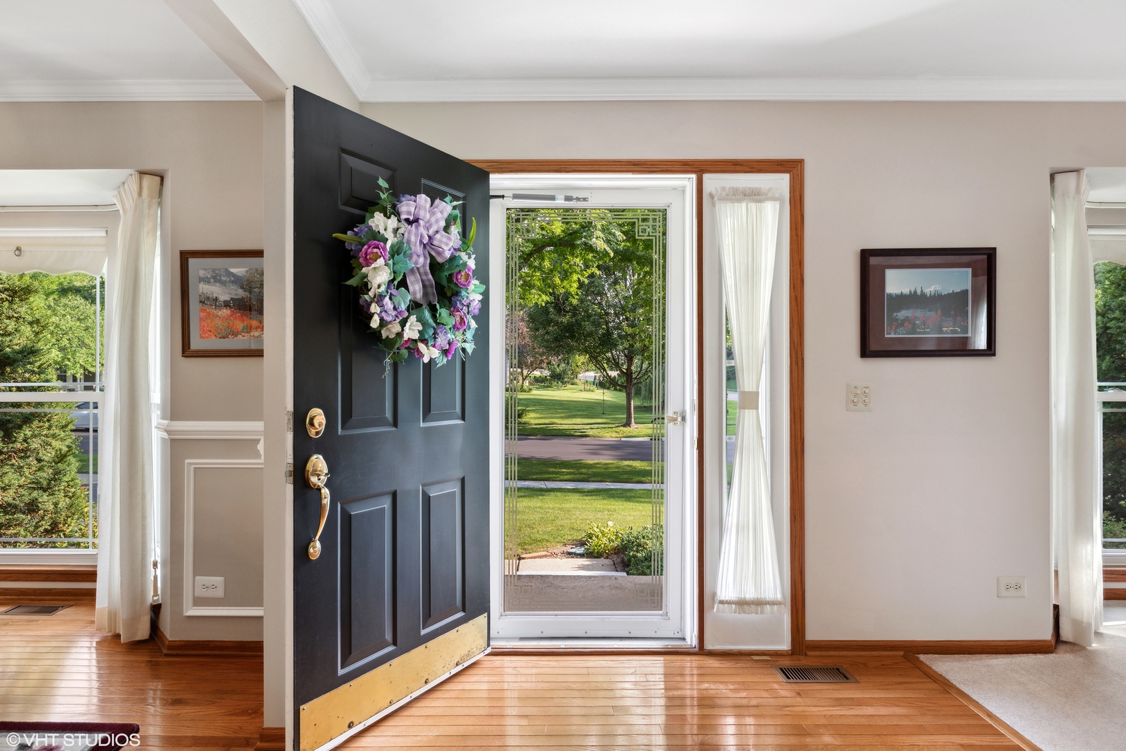 966 Ridgewood Drive Cary, IL 60013 - Photo 2 of 31 a view of a hallway with wooden floor and a living room