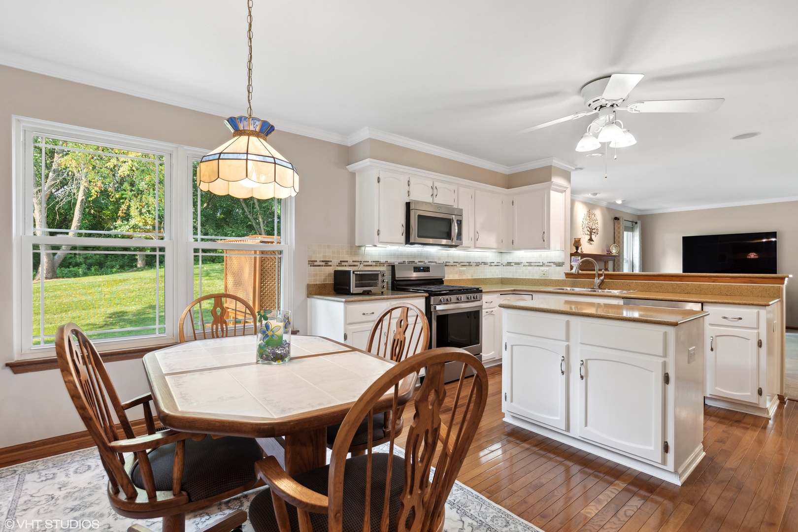 966 Ridgewood Drive Cary, IL 60013 - Photo 8 of 31 a kitchen with a table chairs sink and cabinets