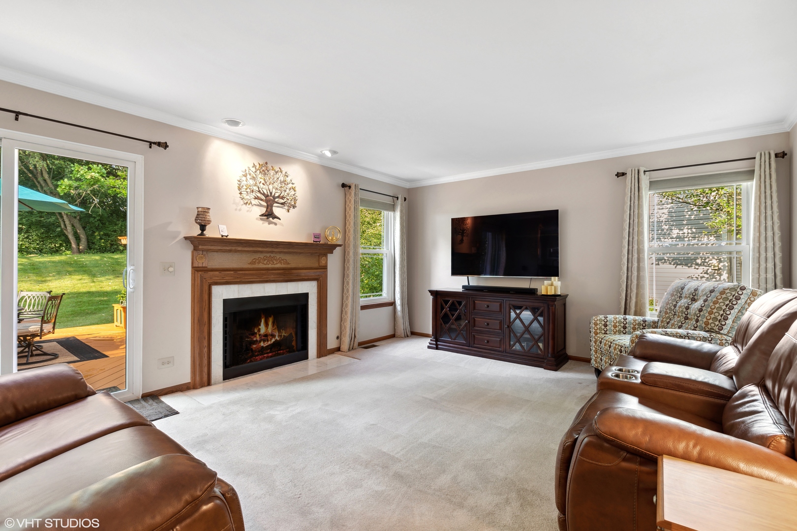 966 Ridgewood Drive Cary, IL 60013 - Photo 9 of 31 a living room with furniture a flat screen tv and a fireplace