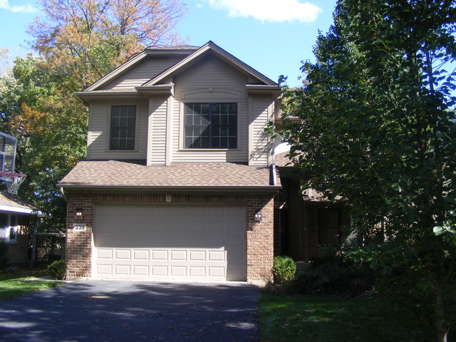 339 Ridge Road Highland Park, IL 60035 - Photo 1 of 9 a front view of a house with a yard and garage