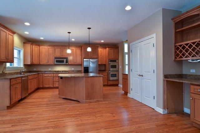 339 Ridge Road Highland Park, IL 60035 - Photo 4 of 9 a large kitchen with granite countertop a large counter top stainless steel appliances and cabinets