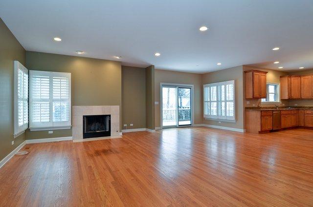 339 Ridge Road Highland Park, IL 60035 - Photo 5 of 9 an empty room with wooden floor fireplace and windows