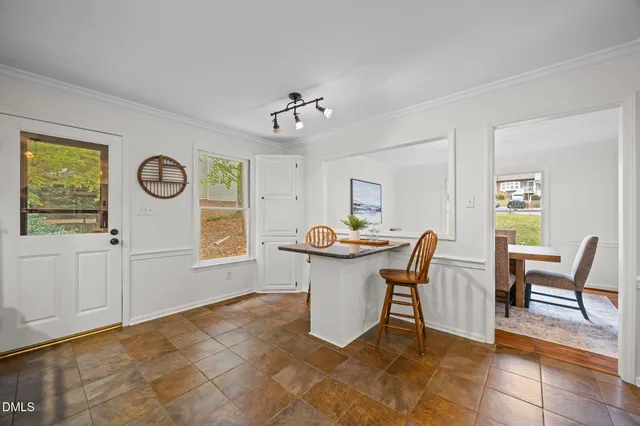 a view of a dining room with furniture and window