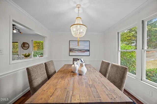 a view of a dining room and a table chairs