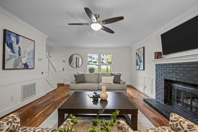 a living room with furniture fireplace and flat screen tv