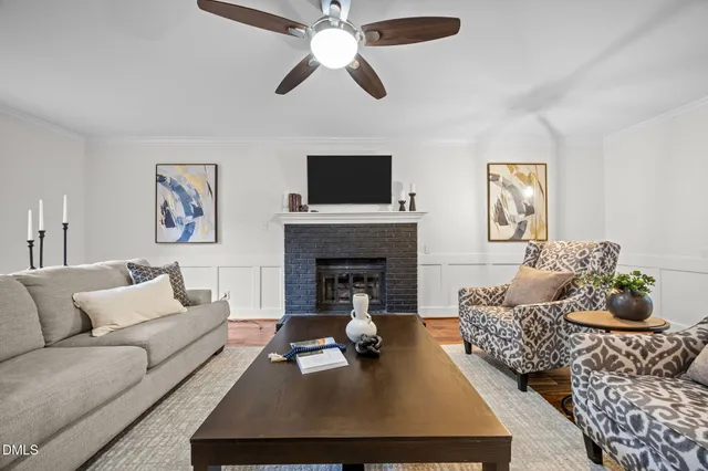 a living room with furniture fireplace and window