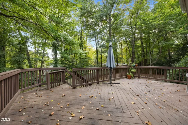 a view of balcony with wooden floor and fence