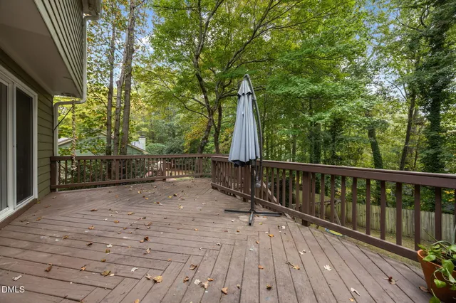 a view of balcony with wooden floor and fence
