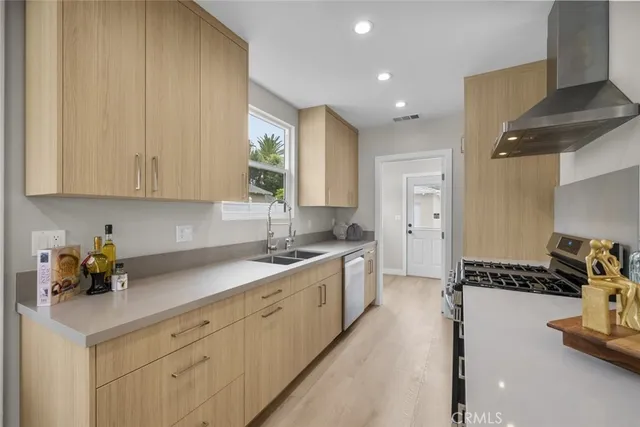 a kitchen with a sink stove and cabinets