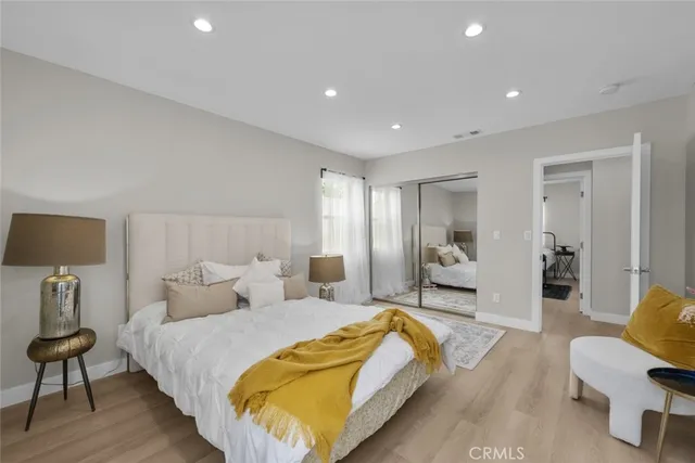 a spacious bedroom with a bed and a couch