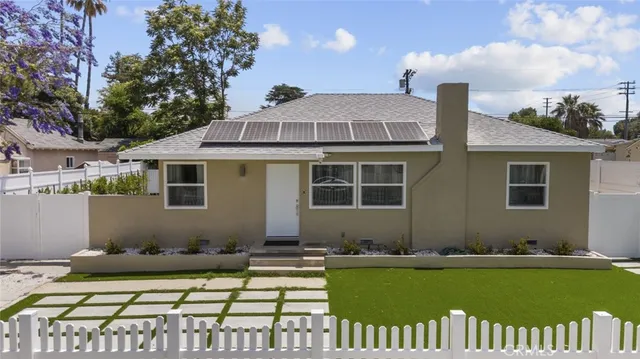 a front view of a house with a garden and patio