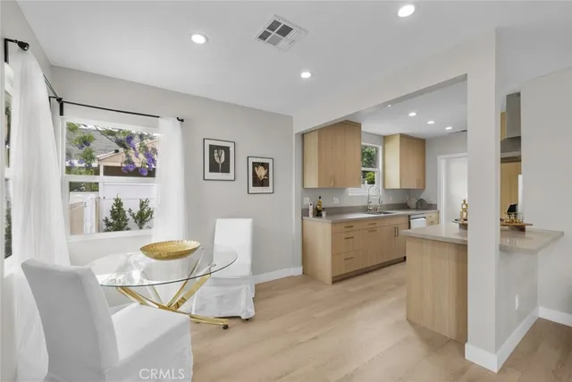 a large kitchen with a table and chairs