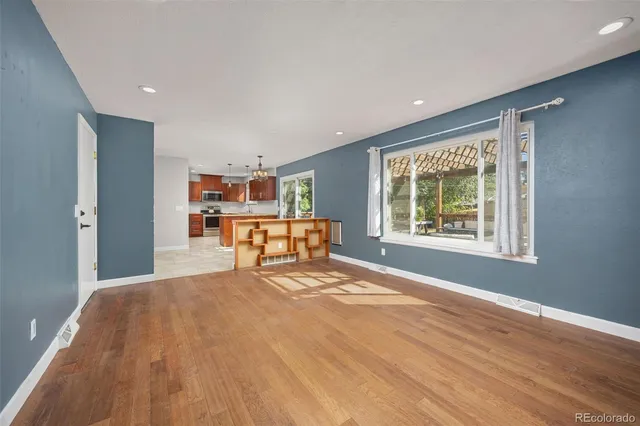 a large bedroom with a bed and a window