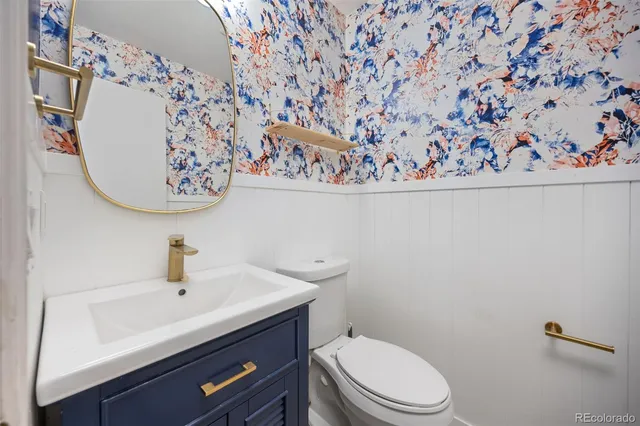 a bathroom with a toilet sink and mirror