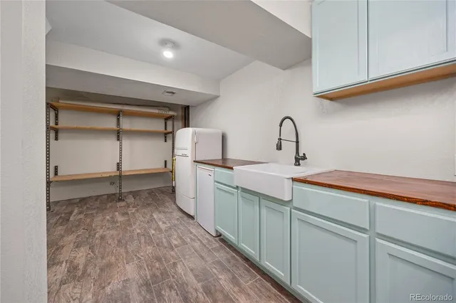 a kitchen with white cabinets and a sink