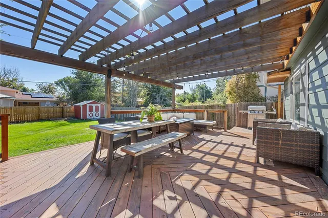 a view of a patio with dining table and chairs with wooden floor