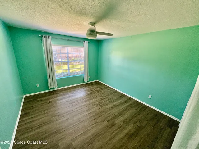 a view of empty room with window and outdoor space