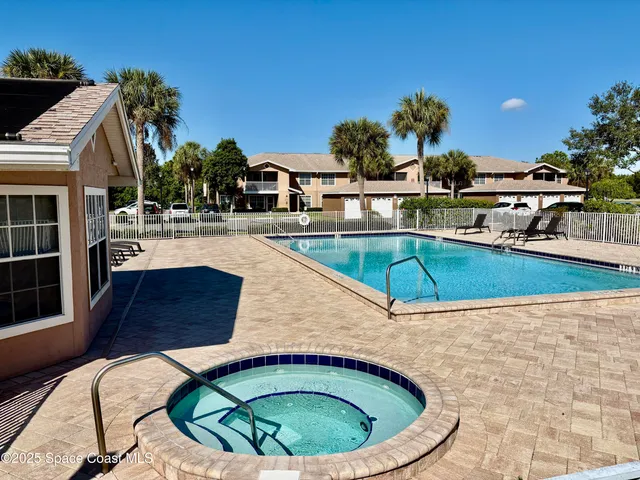 a view of a house with swimming pool and sitting area