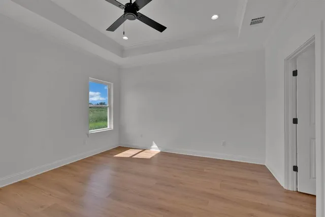 a view of an empty room and wooden floor