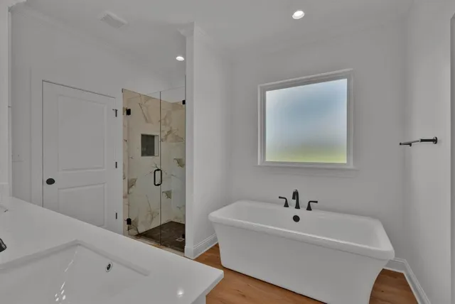 a bathroom with a double vanity sink mirror and shower