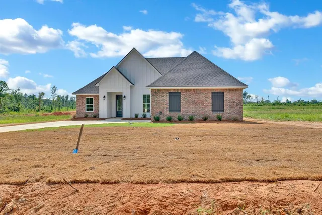a front view of house with a garden