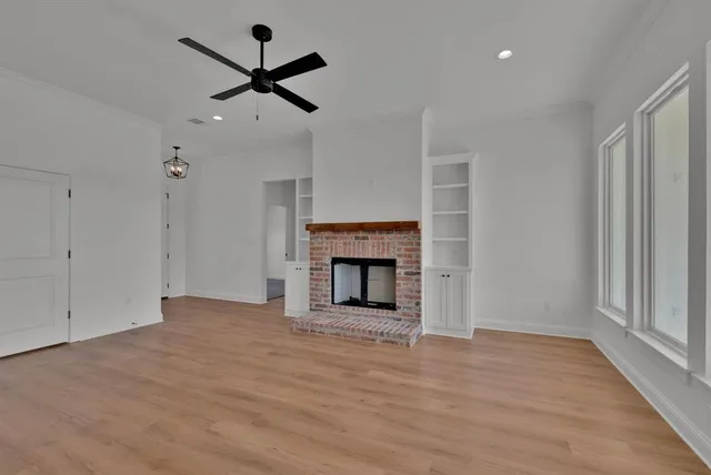 a view of an empty room with a fireplace