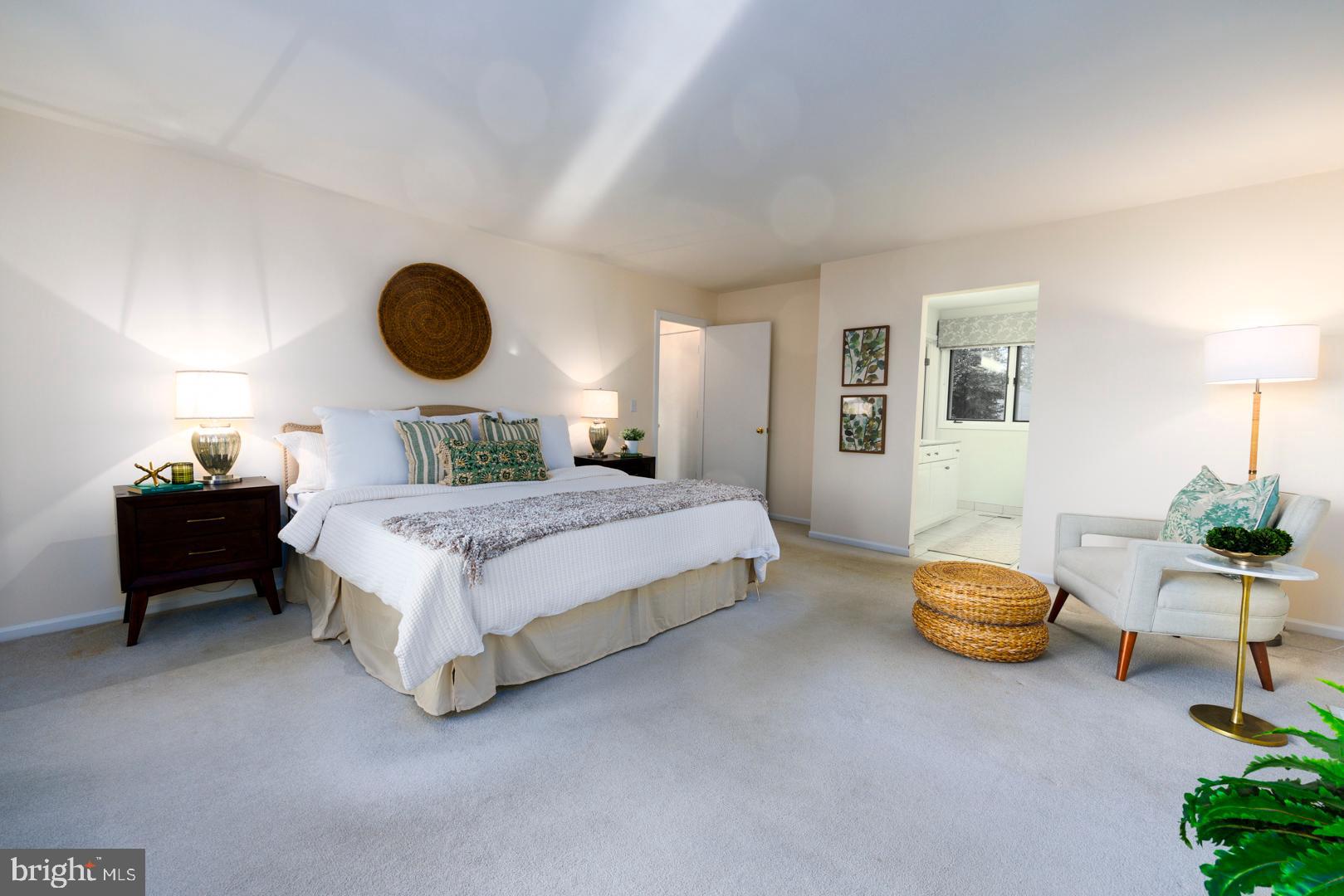 7930 Church Neck Road St. Michaels, MD 21663 - Photo 21 of 41 a bedroom with a bed and a chandelier