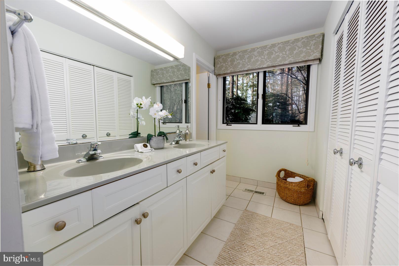 7930 Church Neck Road St. Michaels, MD 21663 - Photo 22 of 41 a bath room with a sink and a mirror