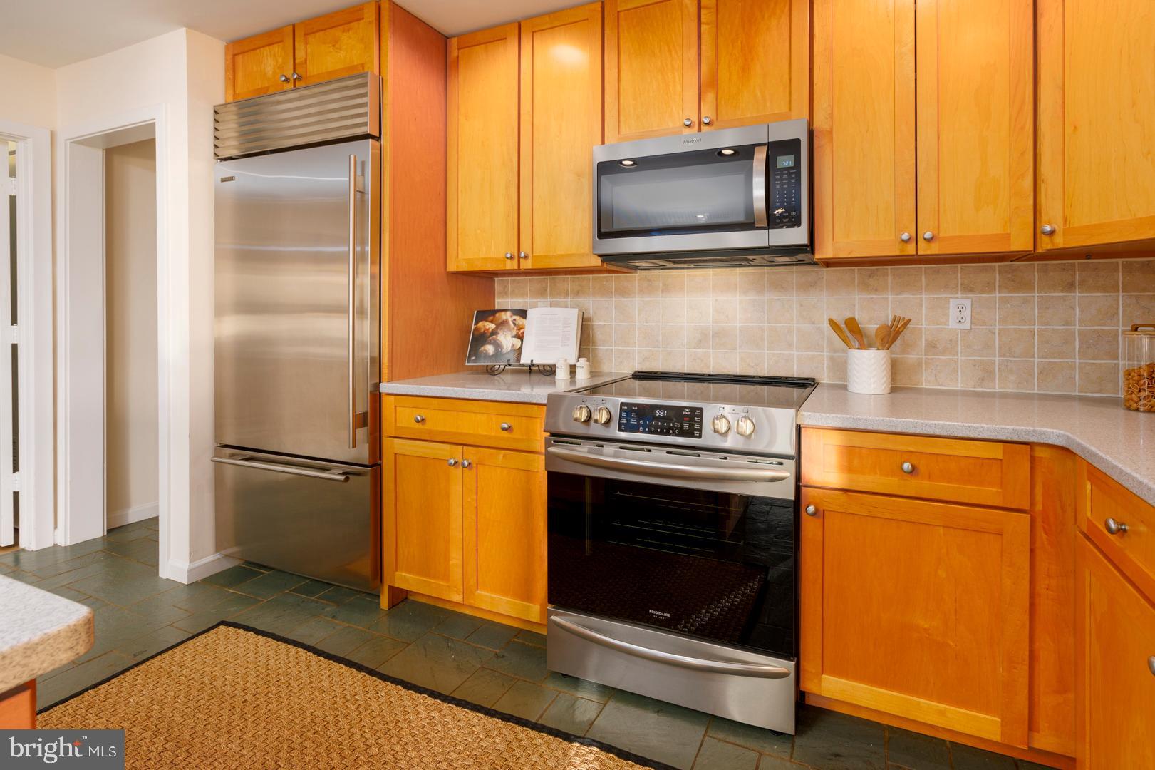 7930 Church Neck Road St. Michaels, MD 21663 - Photo 26 of 41 a kitchen with a stove microwave and refrigerator