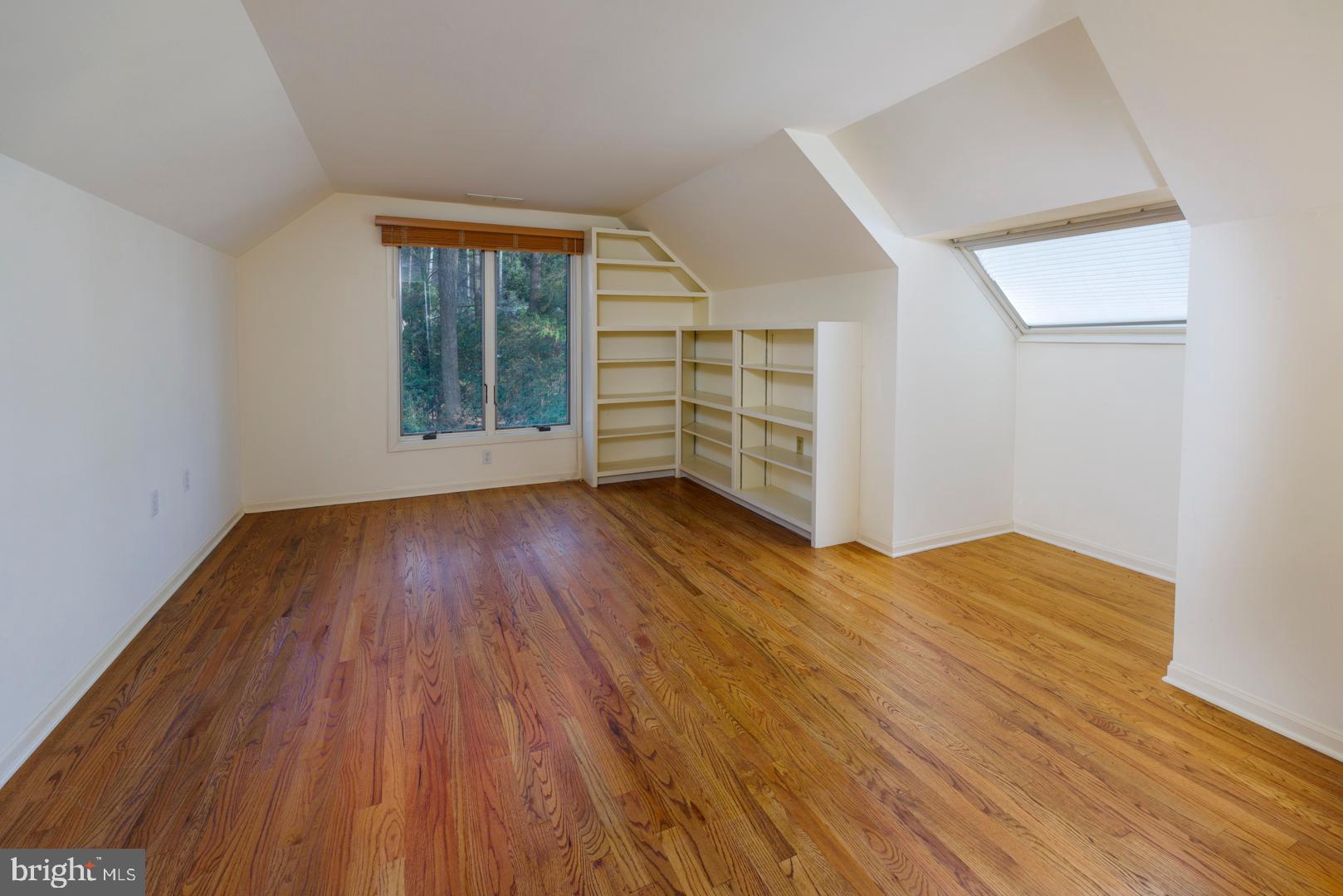 7930 Church Neck Road St. Michaels, MD 21663 - Photo 32 of 41 an empty room with wooden floor and windows