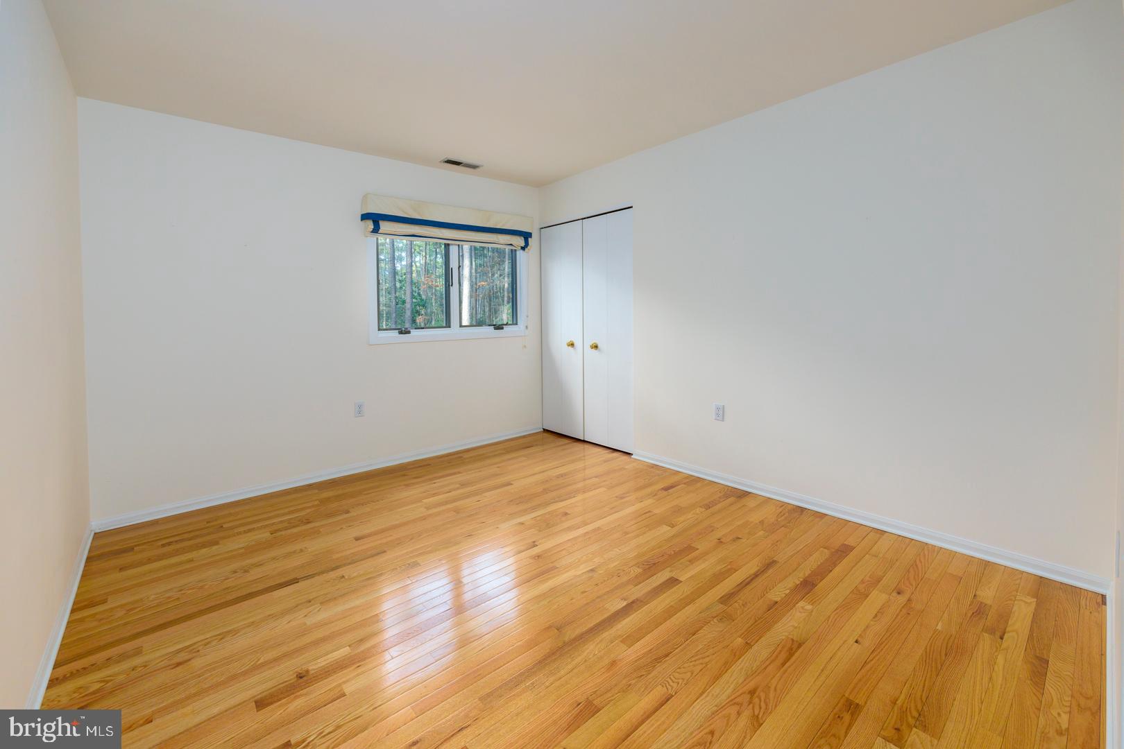 7930 Church Neck Road St. Michaels, MD 21663 - Photo 35 of 41 a view of empty room with wooden floor