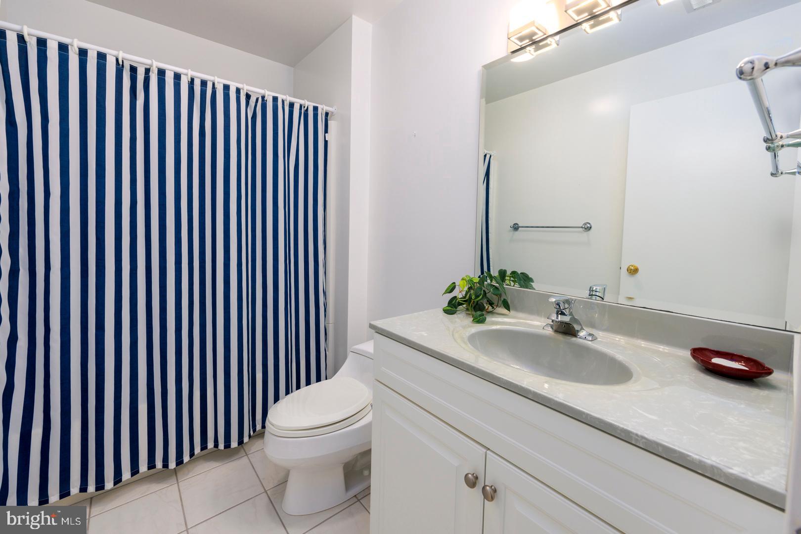 7930 Church Neck Road St. Michaels, MD 21663 - Photo 36 of 41 a bathroom with a sink a toilet and mirror