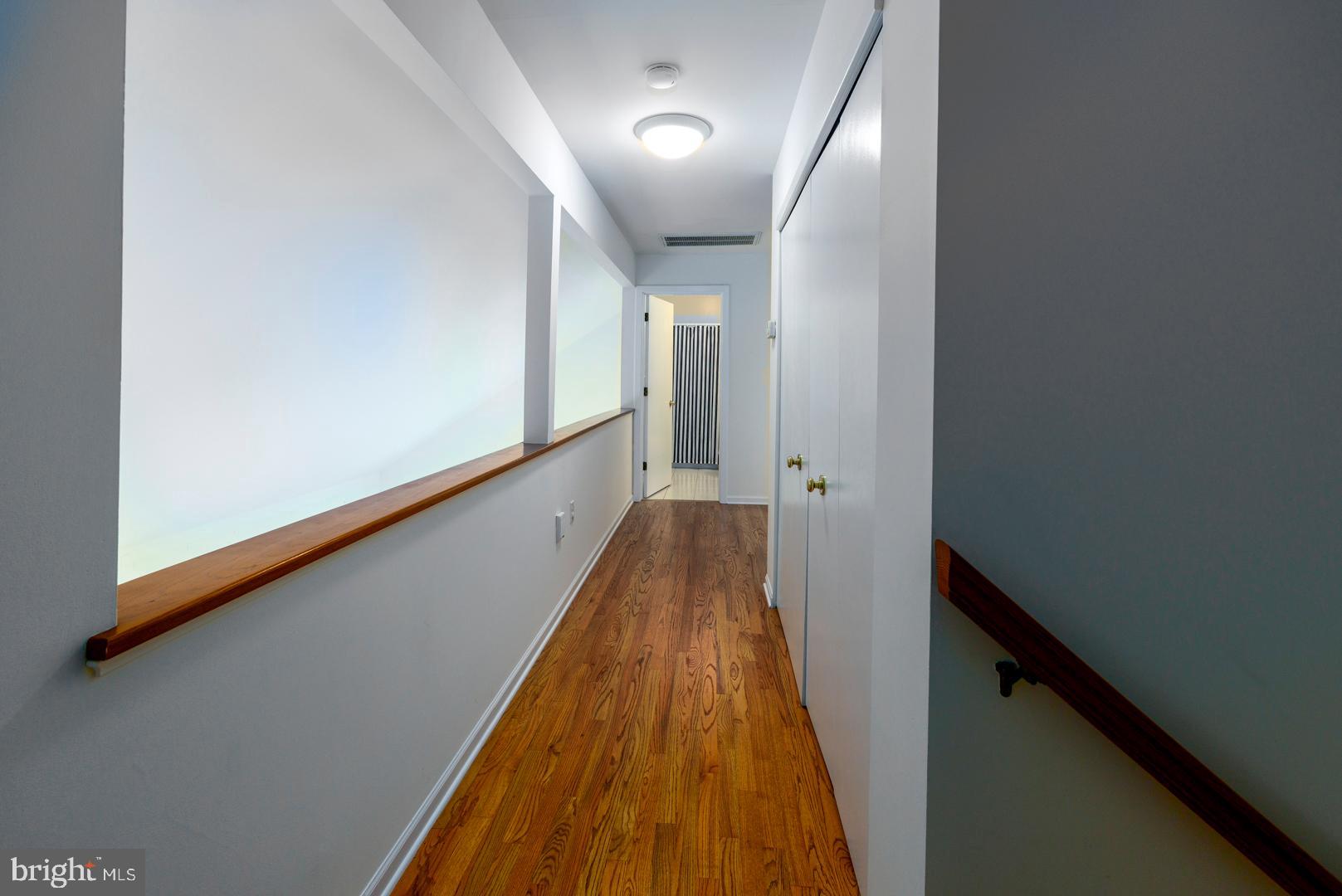 7930 Church Neck Road St. Michaels, MD 21663 - Photo 39 of 41 a view of a hallway with wooden floor and staircase