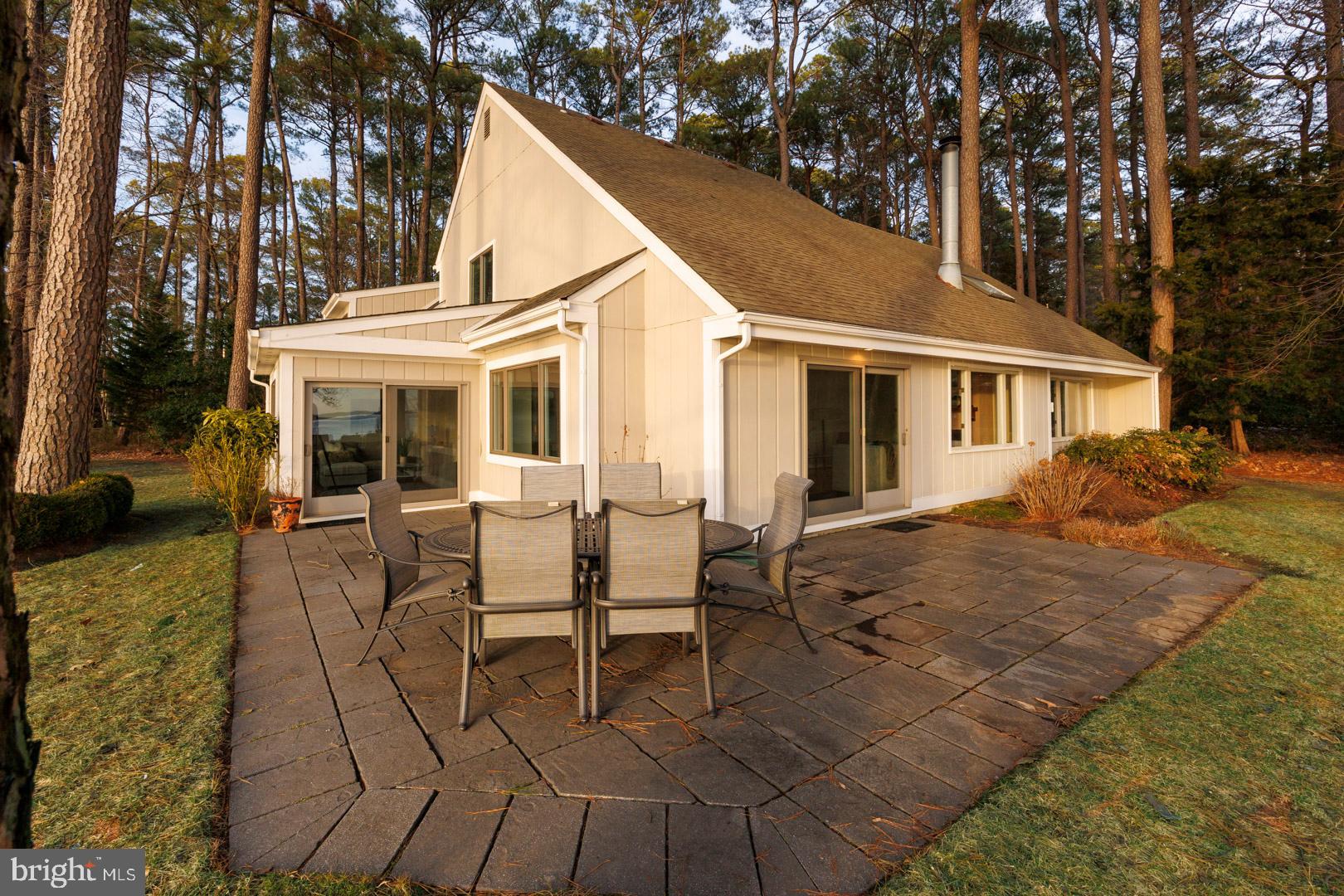 7930 Church Neck Road St. Michaels, MD 21663 - Photo 9 of 41 a view of a white house with a patio
