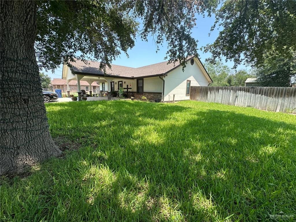 330 West Adams Street Falfurrias, TX 78355 - Photo 11 of 14 a view of a house with a big yard plants and large trees